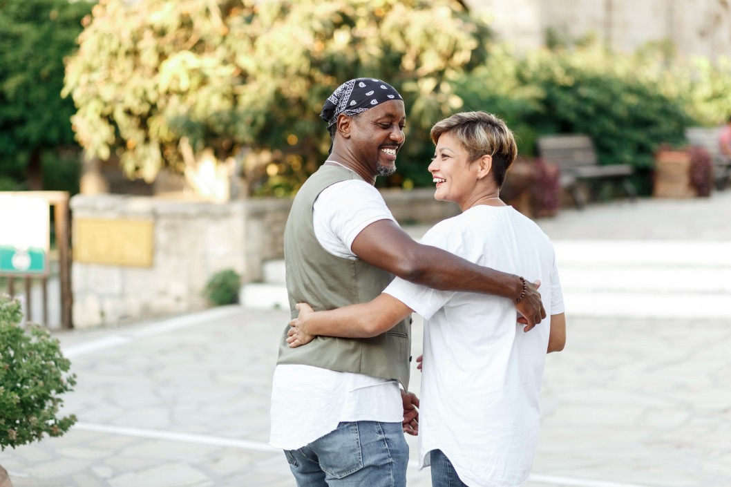 couple smiling and embracing on a walk