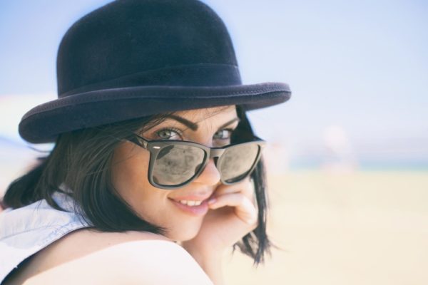 woman with a black hat and sunglasses