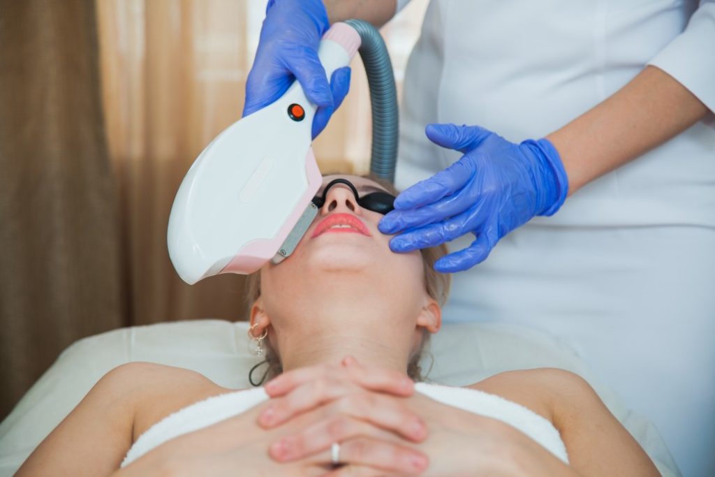 female patient waering protective goggle during laser facial