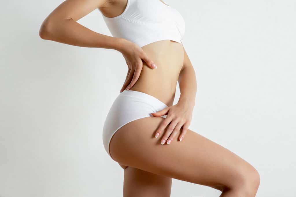 Slim waist and abdomen after liposuction treatment.
