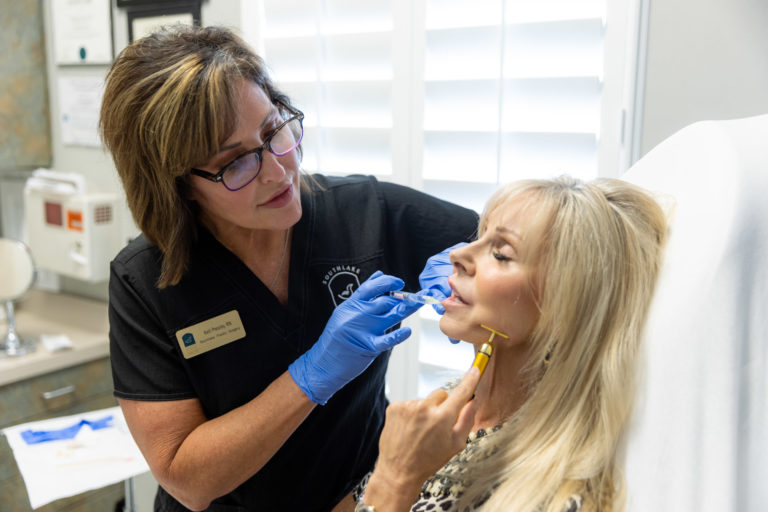 A woman receives a jawline filler for men and women