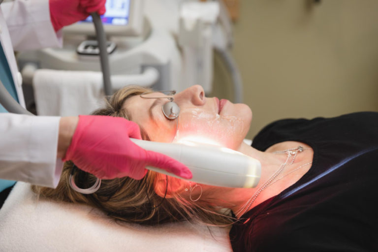 technician using SkinTyte applicator on patient's face