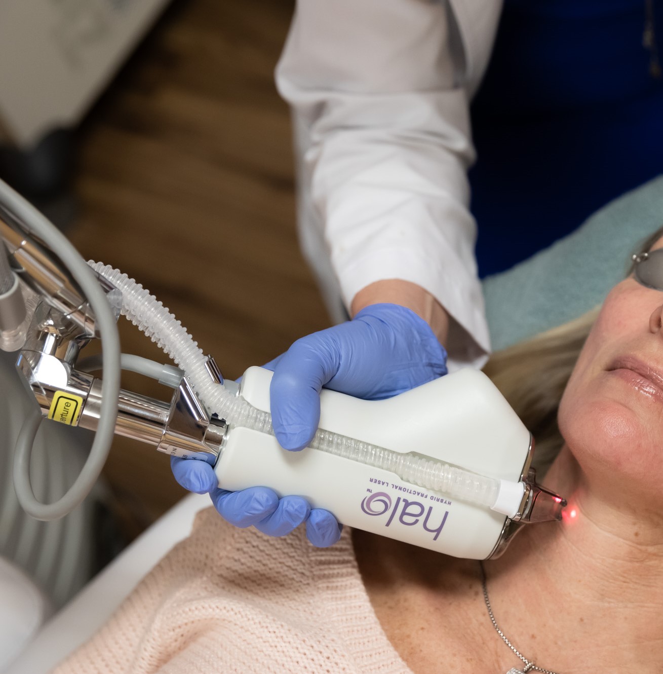 technician using HALO laser on patient's neck