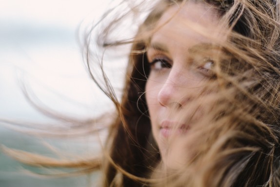 woman's hair blowing in the wind outside
