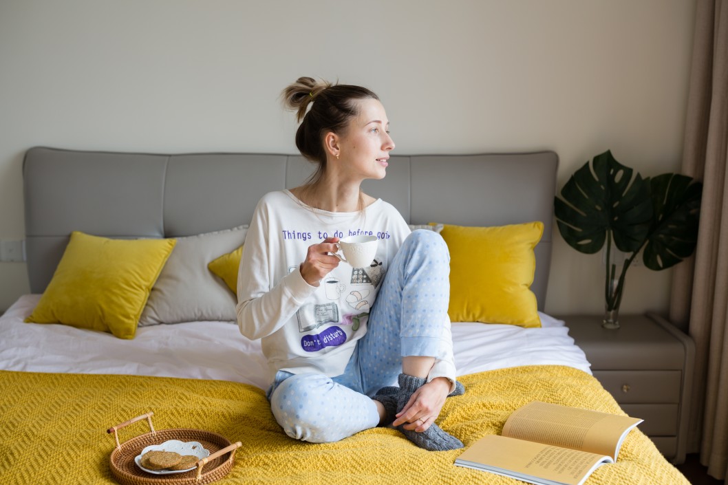 woman relaxing in bed with coffee
