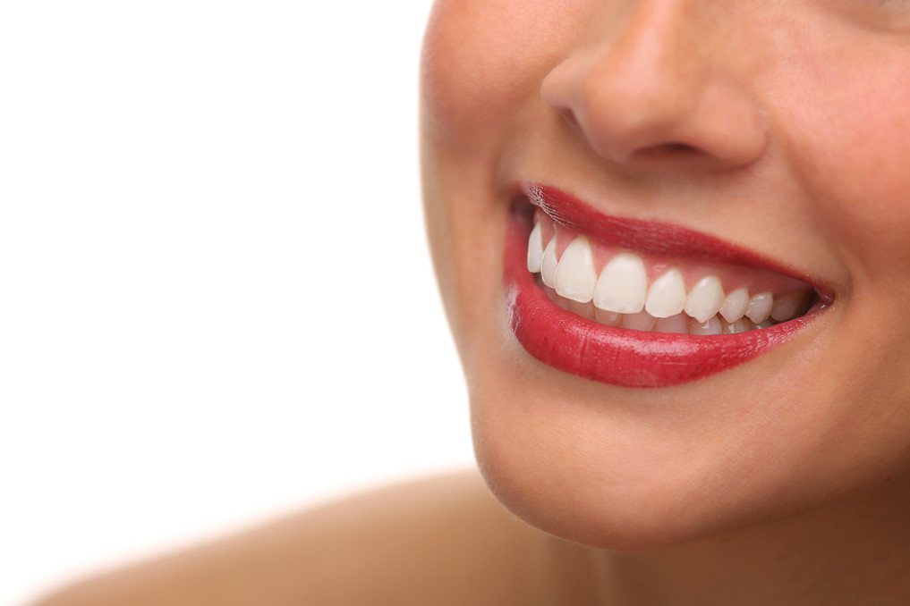 close up of woman's smile with red lipstick