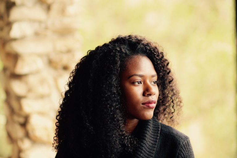 portrait of a young woman in a sweater looking to the side