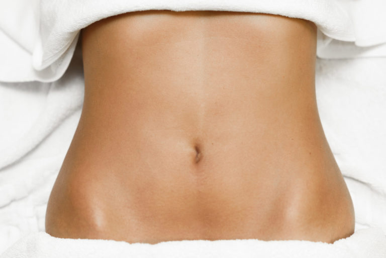 up-close of a tan woman's toned torso