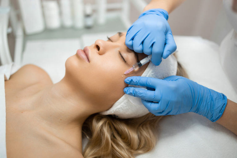 woman getting injected with facial fillers in dallas