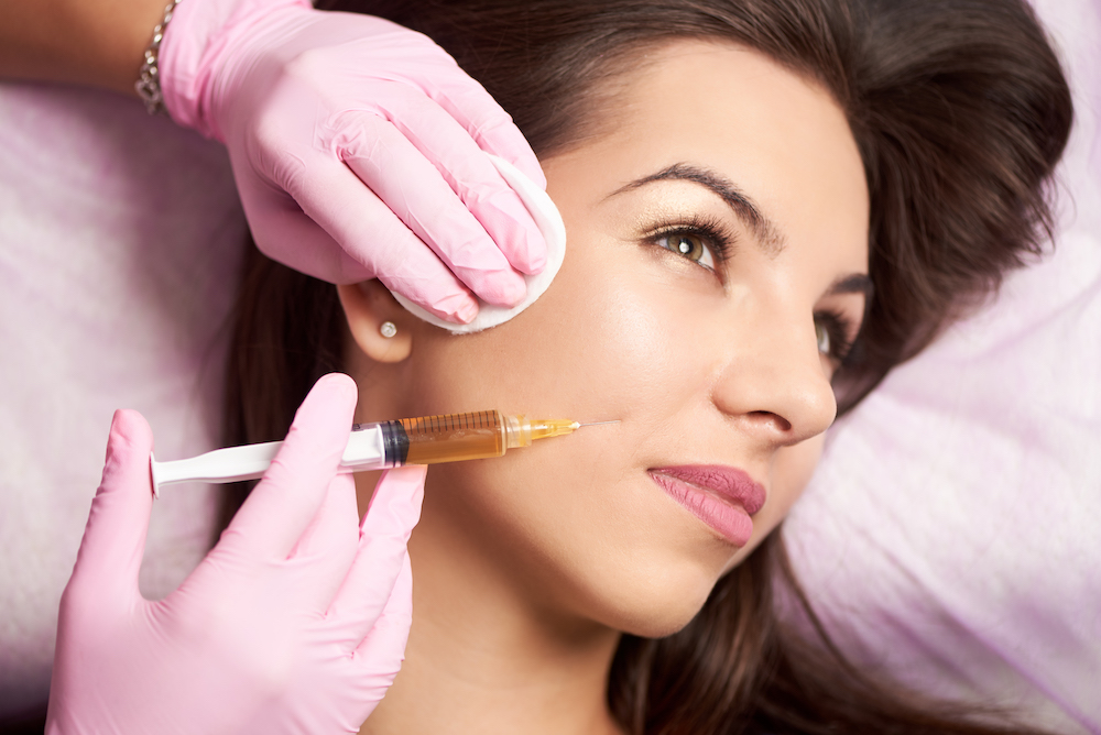 close up of woman being injected with a type of dermal filler
