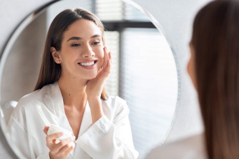 A woman looking in the mirror after a MOXI™ laser treatment in Southlake, TX