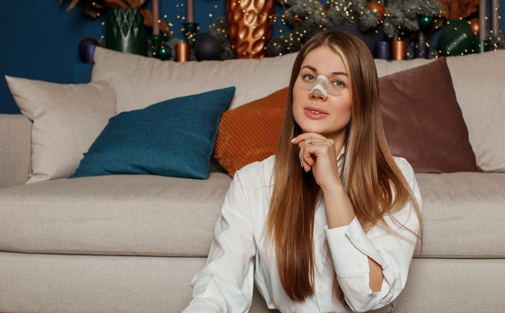 A woman wearing a bandage during rhinoplasty recovery in Southlake, TX